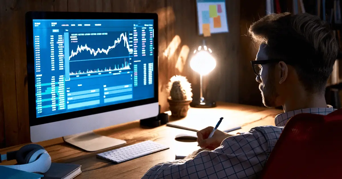 A person using a laptop to analyze stock market data